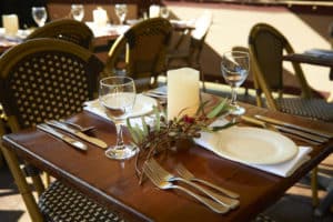 Elegant table setting on PS Emmylou with wine glasses, cutlery, and a native floral centrepiece.